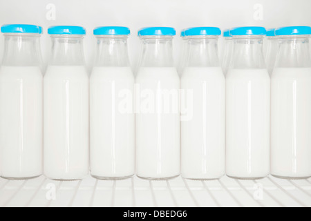 Glass bottles of organic milk in the fridge Stock Photo