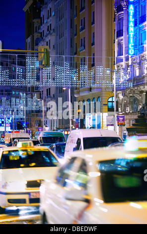 Traffic at Gran via street with string lights at Christmas time. Madrid. Spain. Madrid. Spain. Stock Photo