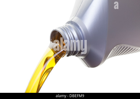 Pouring oil from a jug, shot on a whit background Stock Photo