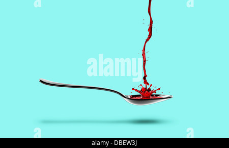 Red medicine pouring into spoon Stock Photo