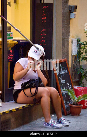 Deena Nicole Cortese Deena was desperately trying to leave work at the Pizzeria as soon as possible to get ready to go out and party at Grand Central Night Club. Ronnie was sat with her outside for a bit drinking beer whilst Deena was supping on an ice-te Stock Photo