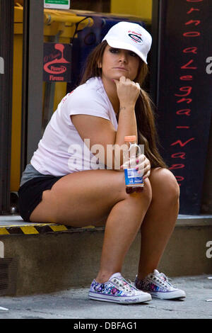 Deena Nicole Cortese Deena was desperately trying to leave work at the Pizzeria as soon as possible to get ready to go out and party at Grand Central Night Club. Ronnie was sat with her outside for a bit drinking beer whilst Deena was supping on an ice-te Stock Photo