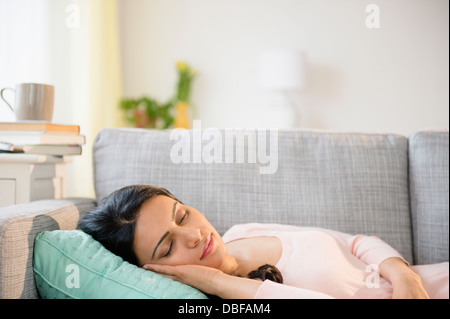 Indian woman napping on sofa Stock Photo