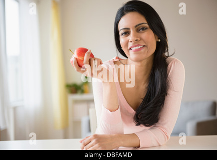 Indian woman eating fruit Stock Photo