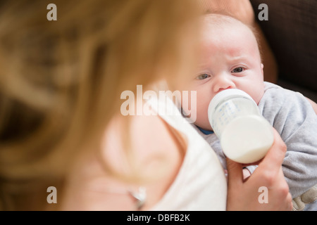 Caucasian mother feeding baby Stock Photo