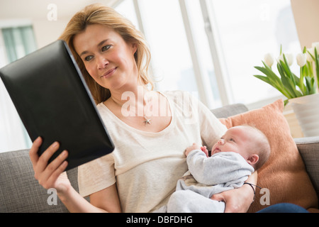 Caucasian mother with baby using tablet computer Stock Photo