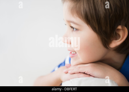 Hispanic boy resting chin on hands Stock Photo