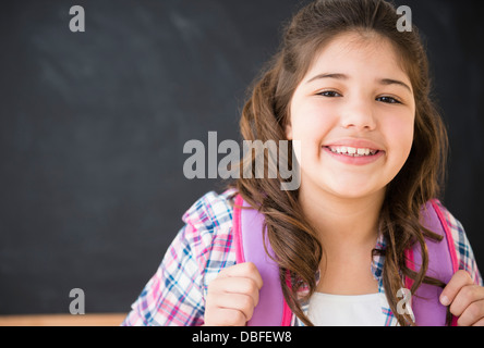 Hispanic girl smiling in classroom Stock Photo