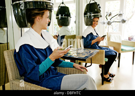 Women having hair done in salon Stock Photo