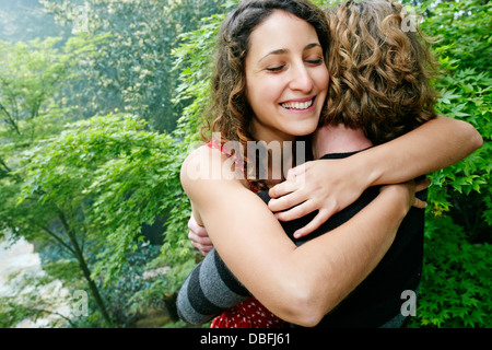 Smiling couple hugging outdoors Stock Photo