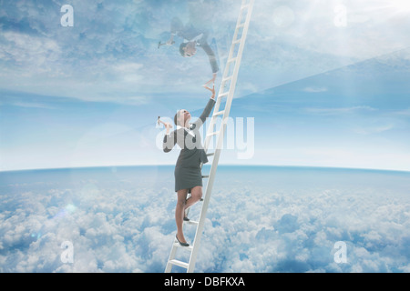 African American businesswoman on ladder to glass ceiling Stock Photo