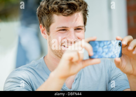 Man using cell phone outdoors Stock Photo