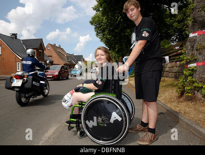 Visitors of the Wacken Open Air (WOA) have glued the festival's logo to the wheels of a wheelchair in Wacken, Germany, 30 July 2013. The world's biggest heavy metal festival will start on 01 August 2013. Photo: Axel Heimken Stock Photo