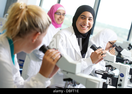 students in laboratory using microscopes Stock Photo