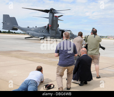 Members of the local media and tail spotters participate in a 352nd Special Operations Group media day July 26, 2013, on RAF Mildenhall, England. Photographers, broadcasters, journalists and tail spotters saw the newly-assigned MC-130J Commando II and CV- Stock Photo