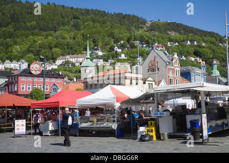 Bergen Norway Europe Market stalls and cafes on Torget selling fish meals very popular with tourists buying fresh fish meals Stock Photo