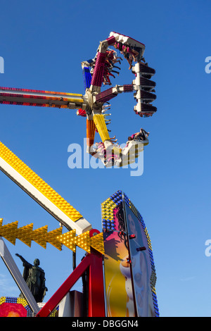 Excited thrillseekers / thrill seekers having fun on fairground attraction G Force at travelling funfair / traveling fun-fair Stock Photo
