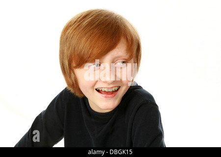 portrait of smiling redhead boy with braces isolated on white Stock Photo