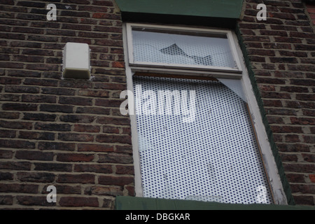 Front of a boarded up house waiting to be demolished, Salem St South, Hendon Sunderland. The front garden wall has collapsed. Stock Photo