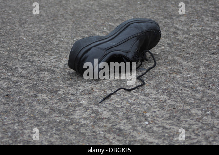 A single shoe on the road Stock Photo