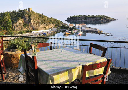 Table in a taverna set  for an evening dinner overlooking the bay in Kardamili,Peloponnese , Greece, Europe Stock Photo