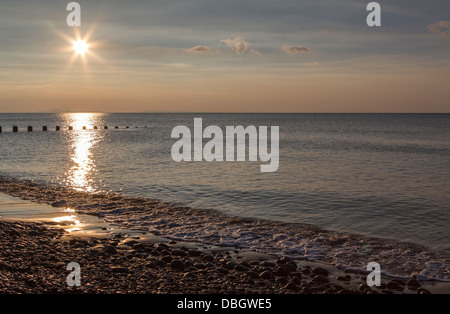 Sunset and reflection on beach at Barmouth, Wales UK Stock Photo