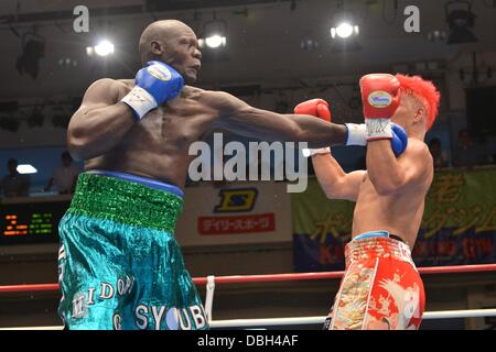 (L-R)  Okello Peter (UGA), Kyotaro Fujimoto (JPN), JULY 25, 2013 - Boxing : Okhello Peter of Uganda hits Kyotaro Fujimoto of Japan in the second round during the vacant Japanese heavyweight title bout at Korakuen Hall in Tokyo, Japan. (Photo by Hiroaki Yamaguchi/AFLO) Stock Photo