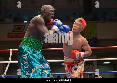 (L-R)  Okello Peter (UGA), Kyotaro Fujimoto (JPN), JULY 25, 2013 - Boxing : Kyotaro Fujimoto of Japan hits Okhello Peter of Uganda in the fourth round during the vacant Japanese heavyweight title bout at Korakuen Hall in Tokyo, Japan. (Photo by Hiroaki Yamaguchi/AFLO) Stock Photo