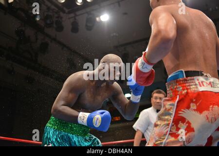 Okello Peter (UGA), JULY 25, 2013 - Boxing : Kyotaro Fujimoto of Japan hits Okhello Peter of Uganda in the sixth round during the vacant Japanese heavyweight title bout at Korakuen Hall in Tokyo, Japan. (Photo by Hiroaki Yamaguchi/AFLO) Stock Photo