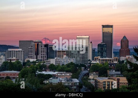 Skyline view of Portland, Oregon, USA with Mt Hood and the rising moon seen in the distance