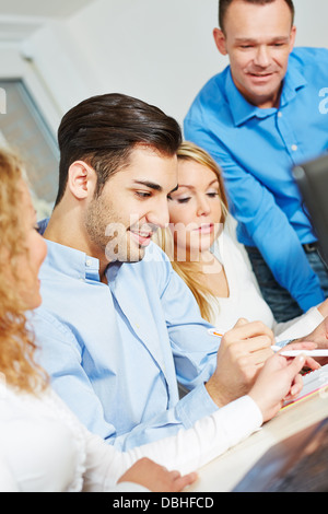 Study group learning in college with a teacher Stock Photo