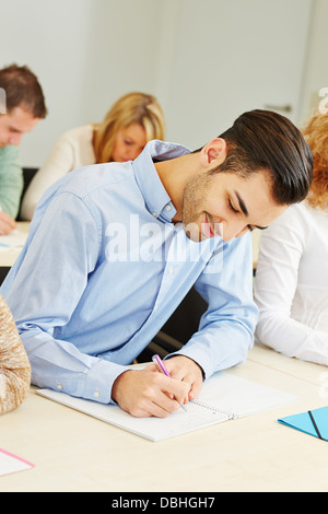 Student studying in course in university and taking notes Stock Photo