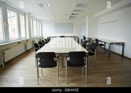 Empty clean conference room with whiteboard and tables and chairs Stock Photo