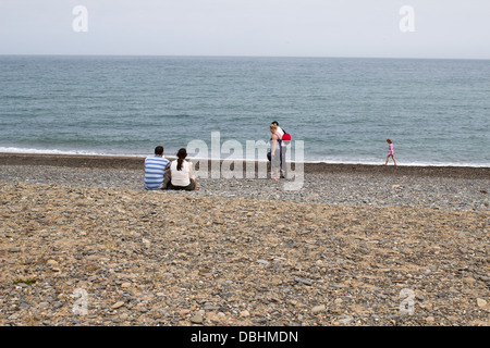People enjoying themselves on a beach. Stock Photo