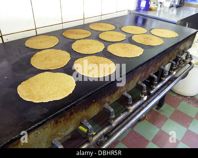 Interior of a traditional Stoke / Staffordshire Oatcake shop, with bright yellow frontage, cooking on an iron griddle 'baxton' Stock Photo