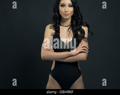 Beautiful Asian woman in her twenties wearing one-piece swimsuit Stock Photo