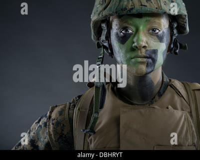 Portrait of Female United States Marine Corps Soldier in utility uniform MARPAT pixelated camouflage with camo face paint