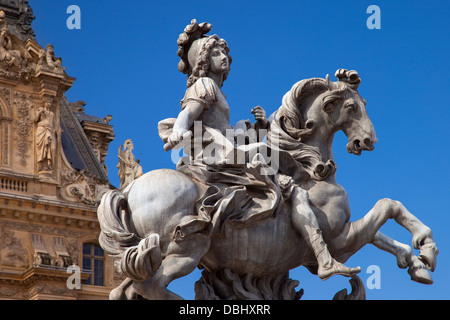 Equestrian statue of Louis XIV below the architecture of Musee du Louvre, Paris France Stock Photo