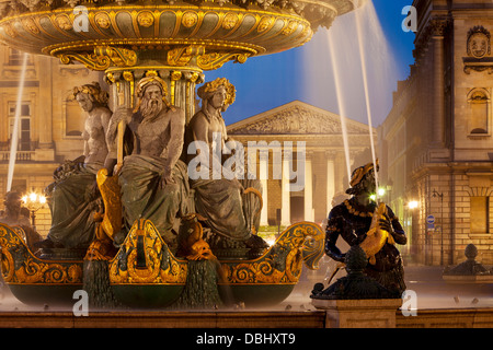 Fontaine des Fleuves - Fountain of Rivers at Place de la Concorde with L'église Sainte-Marie-Madeleine beyond, Paris France Stock Photo