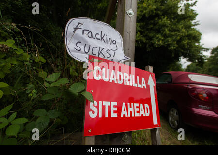 Balcombe, West Sussex, UK. 31st July, 2013. Cuadrilla site sign with fracking sucks additions by protesters. Protest against Cuadrilla drilling & fracking just outside the village of Balcombe in West Sussex. Balcombe, West Sussex, UK. Credit:  martyn wheatley/Alamy Live News Stock Photo
