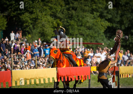 Knight in armour jousting with tarfet at French mediaeval fayre Stock Photo