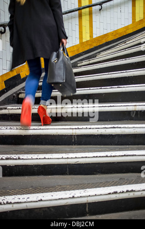 Woman on steps, Covent Garden Underground station, London, United Kingdom Stock Photo