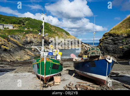 Colourful fishing boats on the beach at Portloe a small fishing village on the south coast of Cornwall Stock Photo