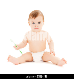 curious baby brushing teeth Stock Photo