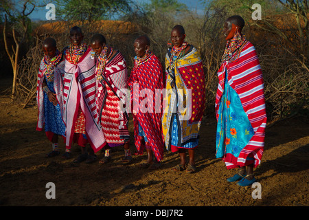 Masai Villagers in traditional clothing outside boma. Selenkay Conservancy area. Kenya, Africa. Stock Photo