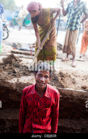 Rural Bangladeshi women perform manual labor carrying dirt for three dollars $3 a day on a road project in Chittagong Bangladesh Stock Photo