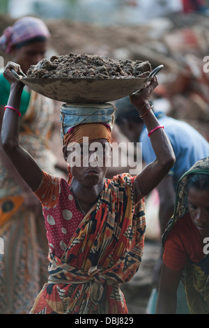 Rural Bangladeshi women perform manual labor carrying dirt for three dollars $3 a day on a road project in Chittagong Bangladesh Stock Photo