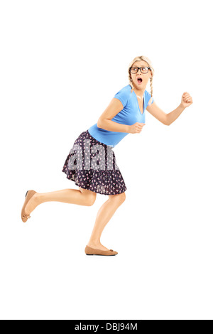 Full length portrait of a scared woman running away isolated on white background Stock Photo