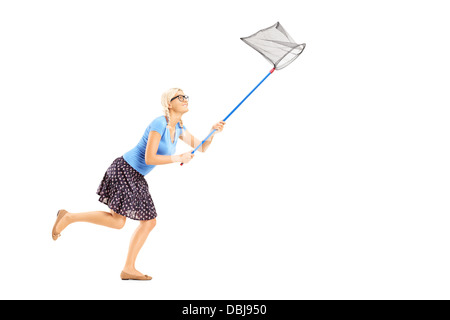Full length portrait of a woman running with butterfly net isolated on white background Stock Photo