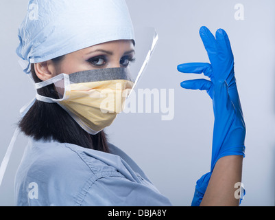 Female Nurse / Doctor / Surgeon wearing scrubs with gloves and mask ...